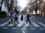 Walk in Footsteps of The Beatles crossing Abbey Road, London, England