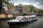 Audio guided tour on a covered boat through the canals of Amsterdam