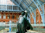 See Sir John Betjeman Statue at St. Pancras, London, England
